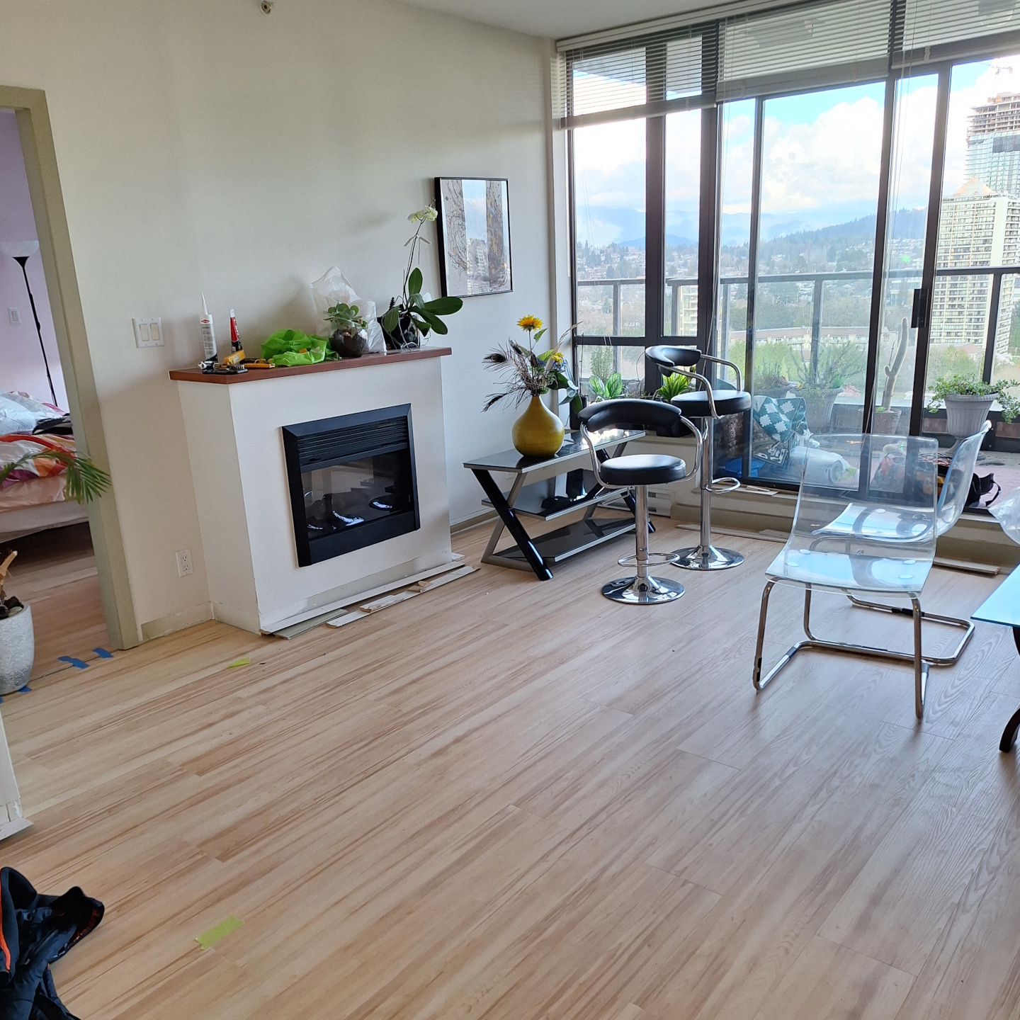 A renovated living room, with newly-installed laminate flooring.
