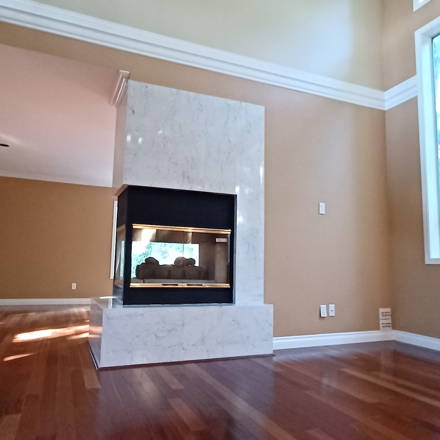 A modern fireplace at the centre of a living room.